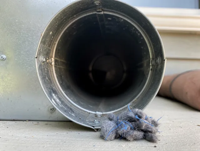 Richmond Hill Dryer Vent Cleaning technician using specialized equipment to clear severe dryer vent blockage in Richmond Hill